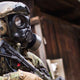 Solider standing sideways while wearing the CM-7M military gas mask