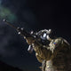 Soldier aiming down his rifle sights while wearing the MIRA Safety CM-7M military gas mask