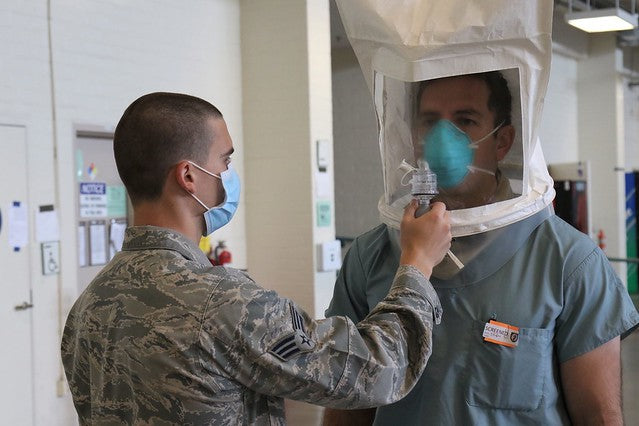 Officer receives an N95 respirator fit test from a military doctor