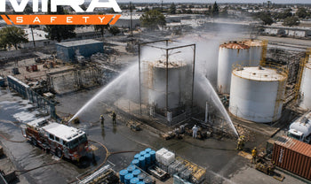 chemical tank being sprayed by firefighters with water. Credit: Ev Buchanan