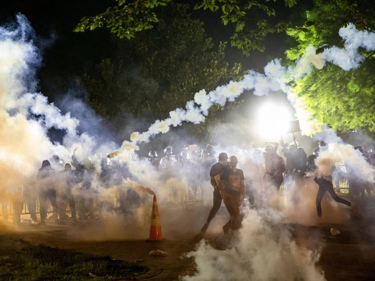 people silhouetted against clouds of smoke