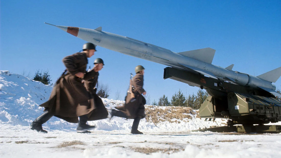 A side shot of Soviet soldiers running past a missile