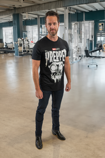 Man wearing a black t-shirt with a graphic design in an indoor setting