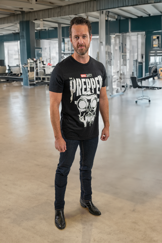 Man wearing a black t-shirt with a graphic design in an indoor setting