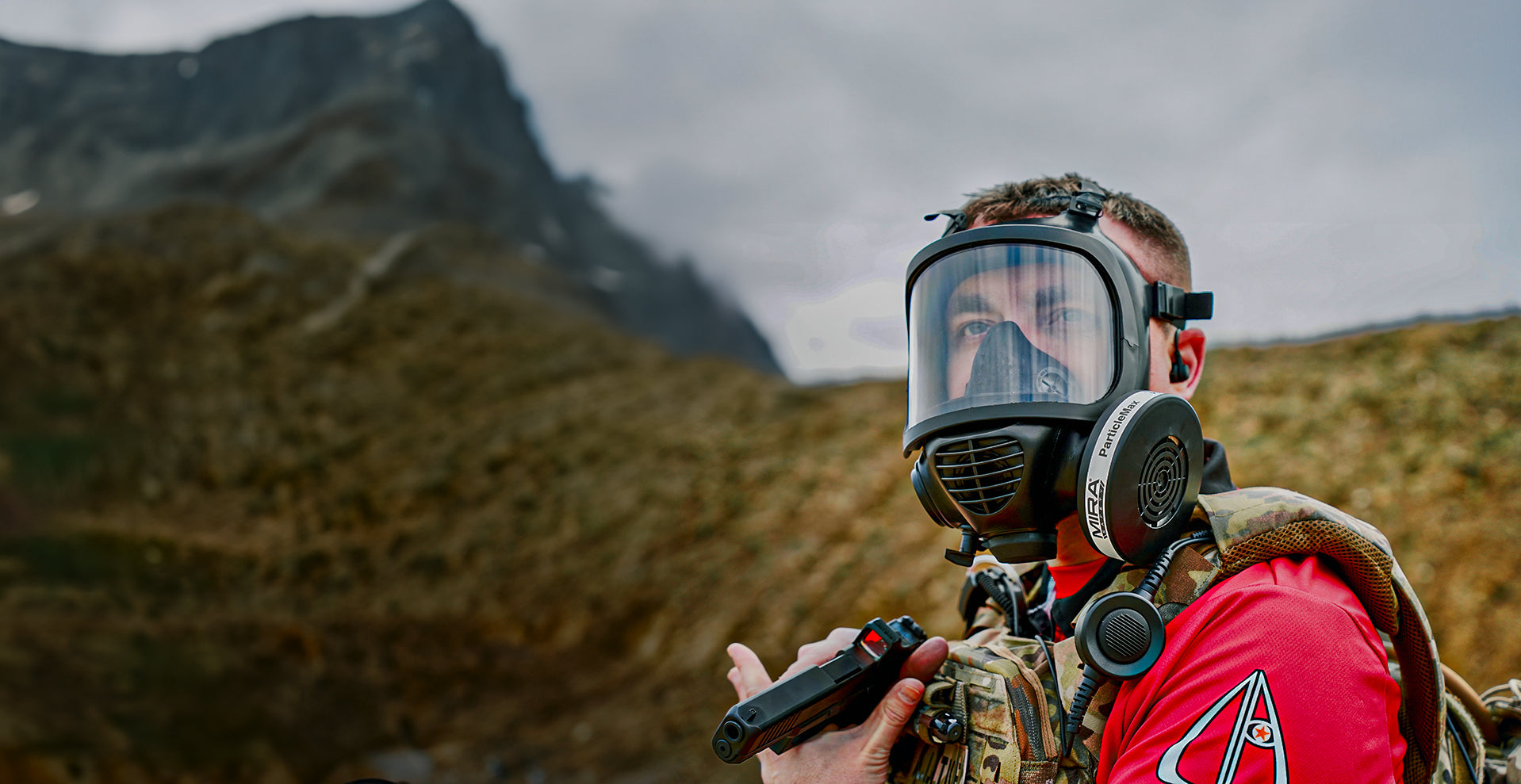 A guy with a Mira Safety mask with mountains behind him