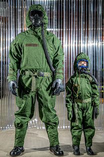 Two individuals wearing green protective suits with hoods against a metallic background