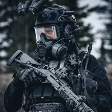 3/4 medium shot view of an operator wearing tactical equipment and gas mask, with a NBC-17 filter and shotgun