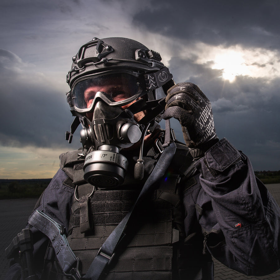 3/4 shot view of a SWAT officer wearing a TAPR mask and a P-CAN Compact filter