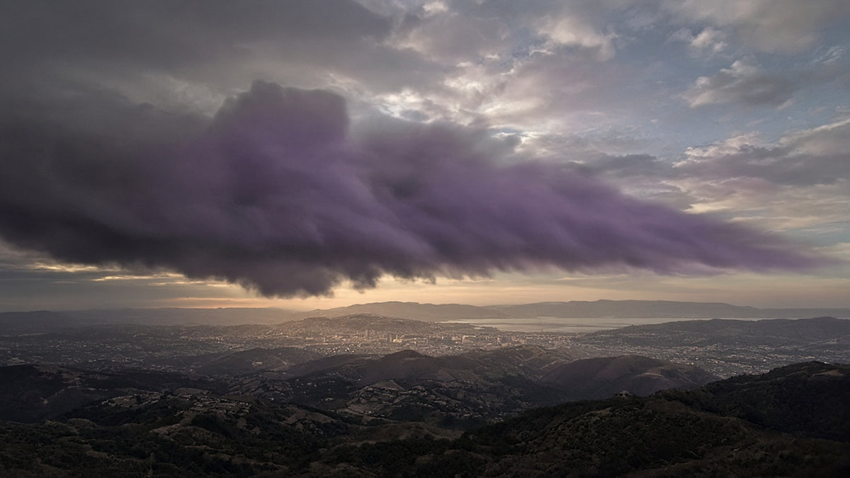 Radioactive fallout cloud drifting downwind over a landscape