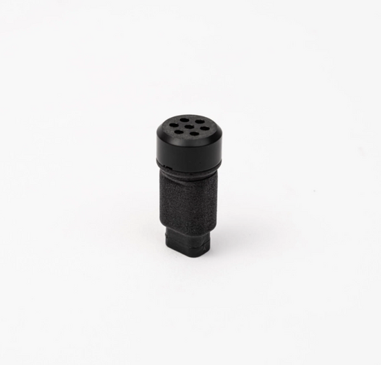 Black cylindrical object with multiple holes on a white background