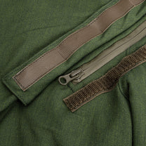 Close-up of a green jacket with a zipper and brown straps