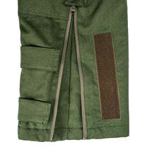 Green military-style jacket with pockets and a patch on a white background