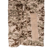 Camouflage cargo pants with multiple pockets and a zipper on a white background
