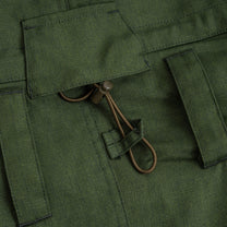 Close-up of green fabric with a button and string detail