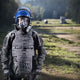 Man wearing riot gear and the MIRA Safety CM-6M riot control gas mask