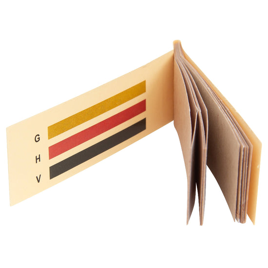 Open beige decon paper with color swatches and letters on a white background