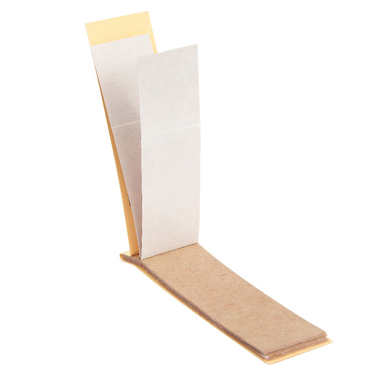 Open decon paper with beige cover and white pages on a white background