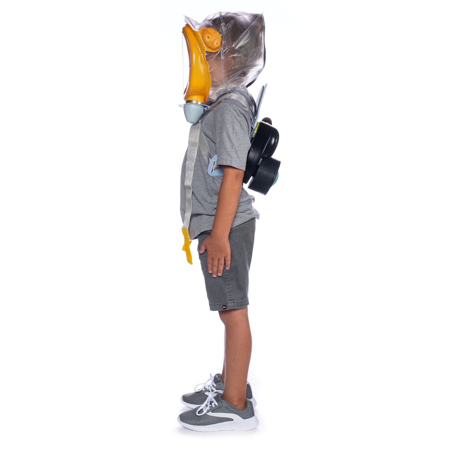 Child standing sideways while wearing the MD-2 Baby Gas Mask