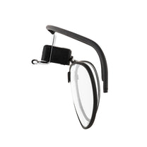 A black spectacle kit designed for military gas masks, featuring a frame with a clip-on attachment for lenses.